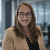 Allison P. Corry in a glass-walled office